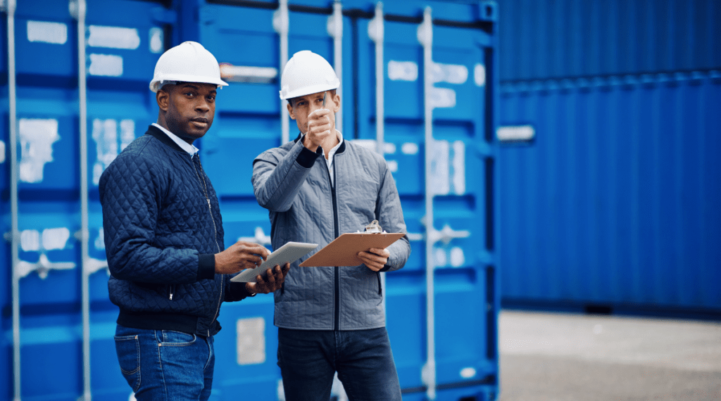 Construction men talking and holding Ipad