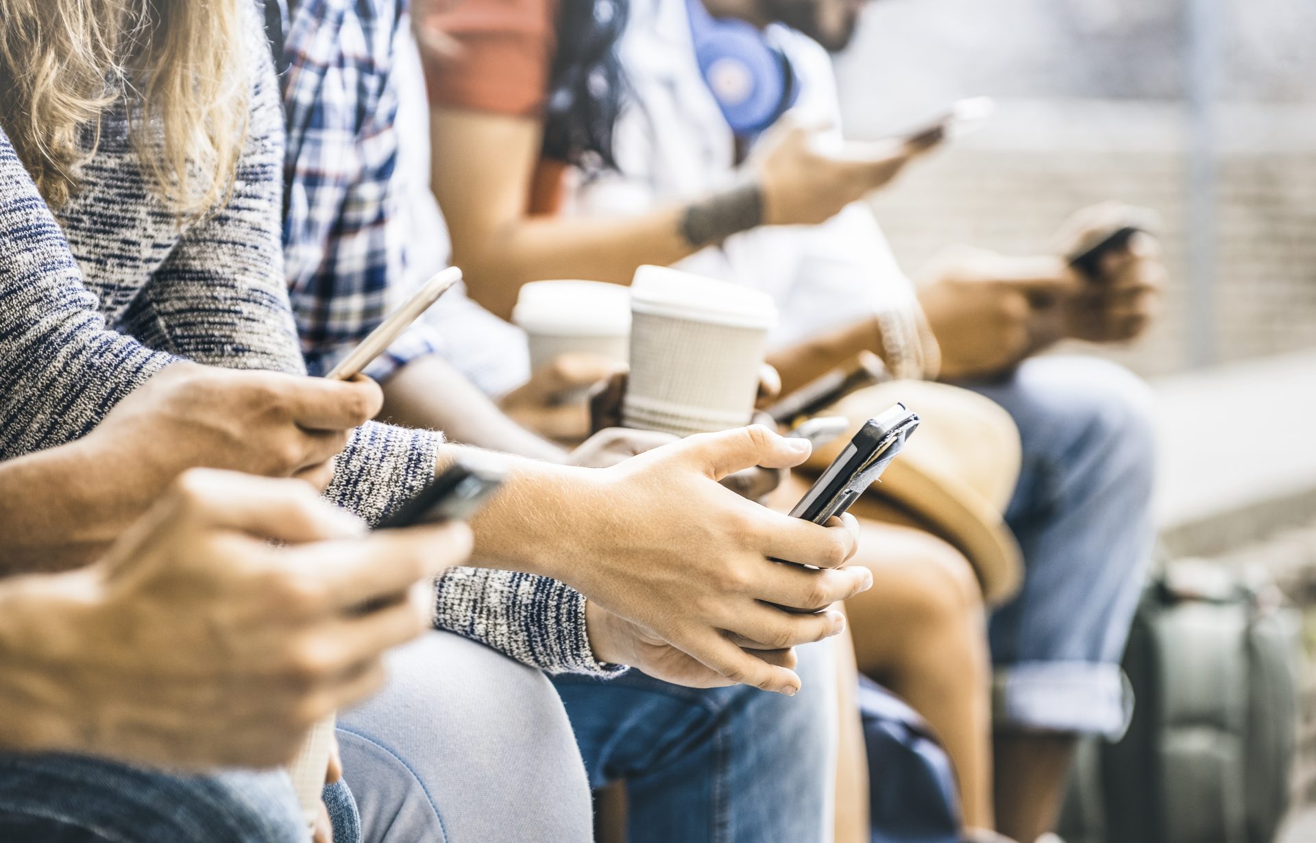 Multicultural friends group using smartphone with coffee at university college break – People hands addicted by mobile smart phone – Technology concept with connected trendy millennials – Filter image